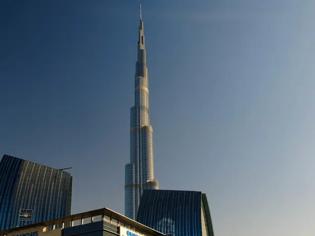 This image consists of buildings, tower, board and the sky. This image is taken may be during a...