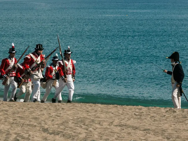 In this picture we can see soldiers standing on the sand by the sea side.
