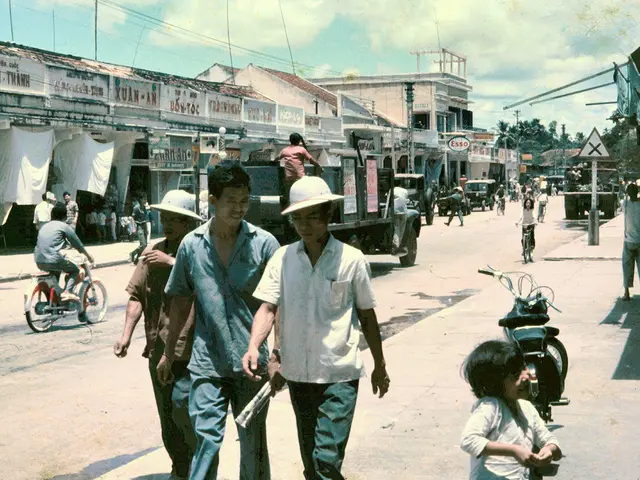 In the image there are three people walking on the road and them there is truck moving and it seems...