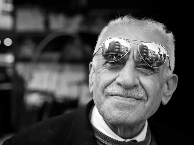 This image is a black and white image. In this image the background is blurred. In the middle of...