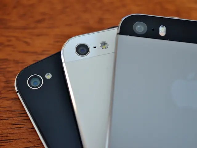 The picture consists of three Phones on a wooden desk.