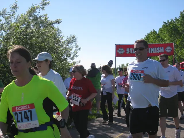 In this picture there is a group of girls and boys running in the marathon race. Behind we can see...